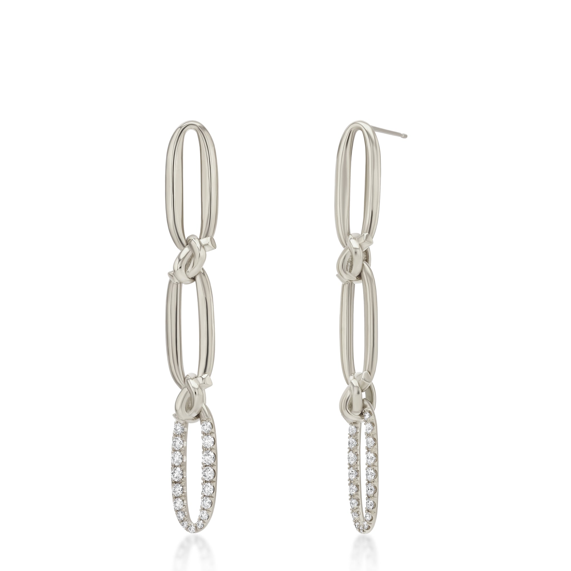 Pair of white gold hoop earrings with diamond accents on a white background